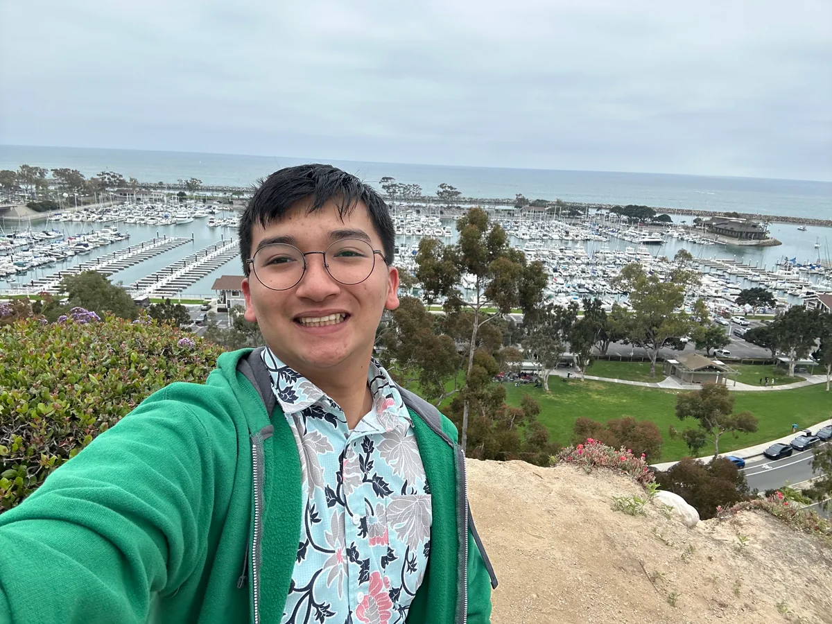 Krish Wu outdoors, smiling at the camera