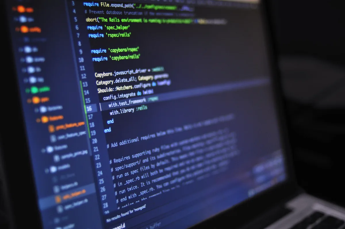 Krish working at a desk with code on screen